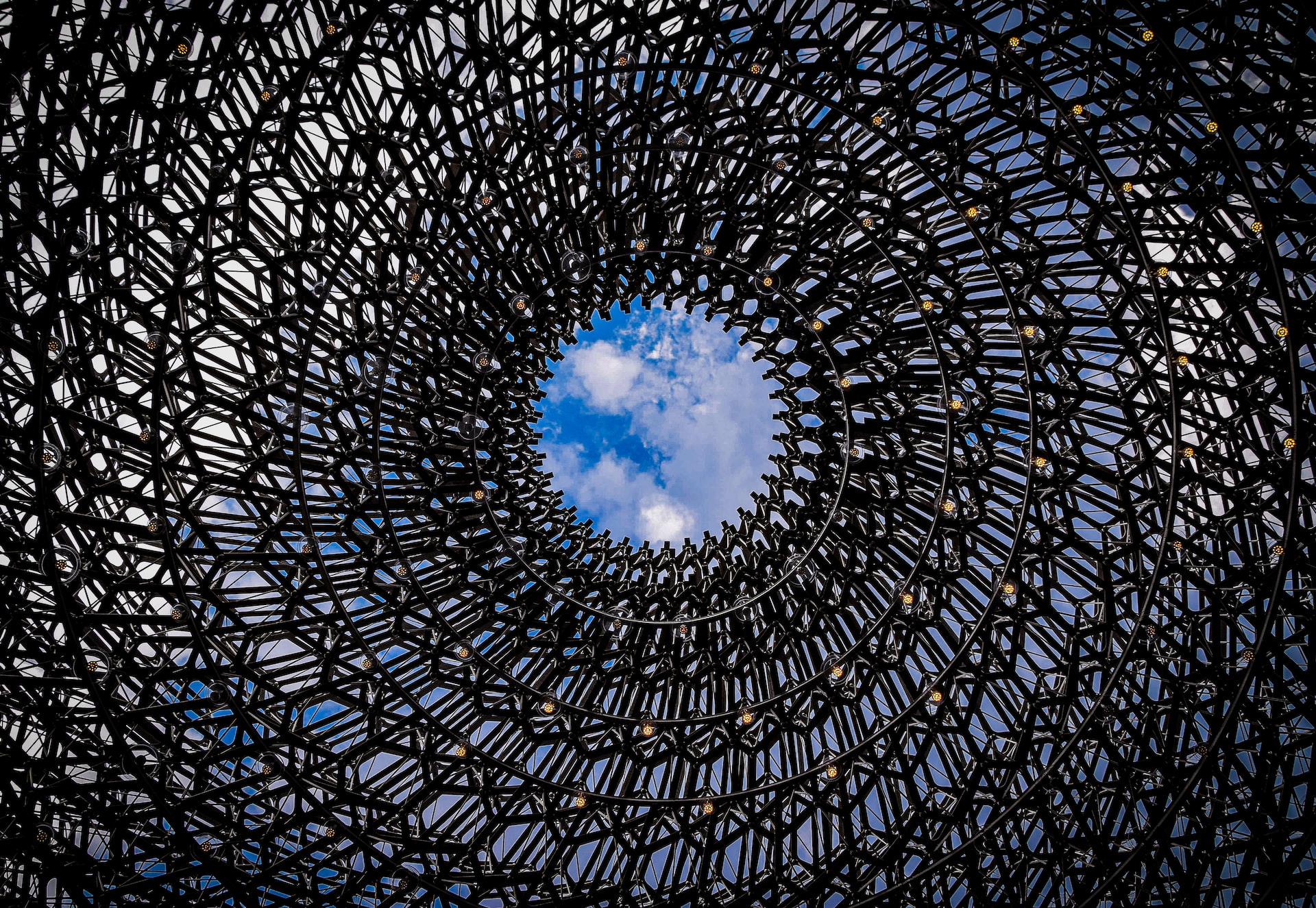 A hand holding a bitcoin, representing online banking and rewards